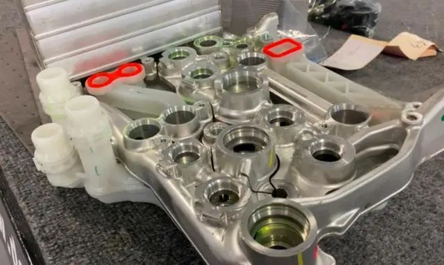 Layered refrigerant and coolant bracket design