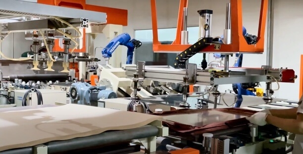 Automated press applying low-loss materials in high-volume 5G PCB manufacturing