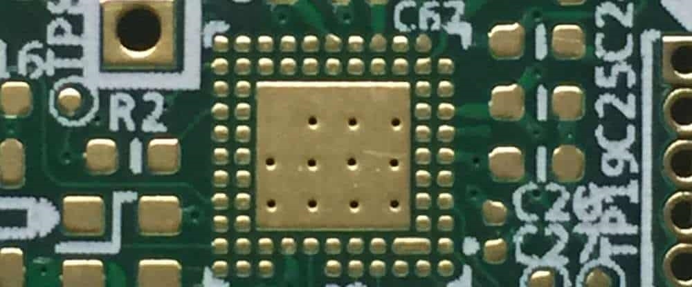 Close-up of a power PCB showing thermal vias for heat dissipation