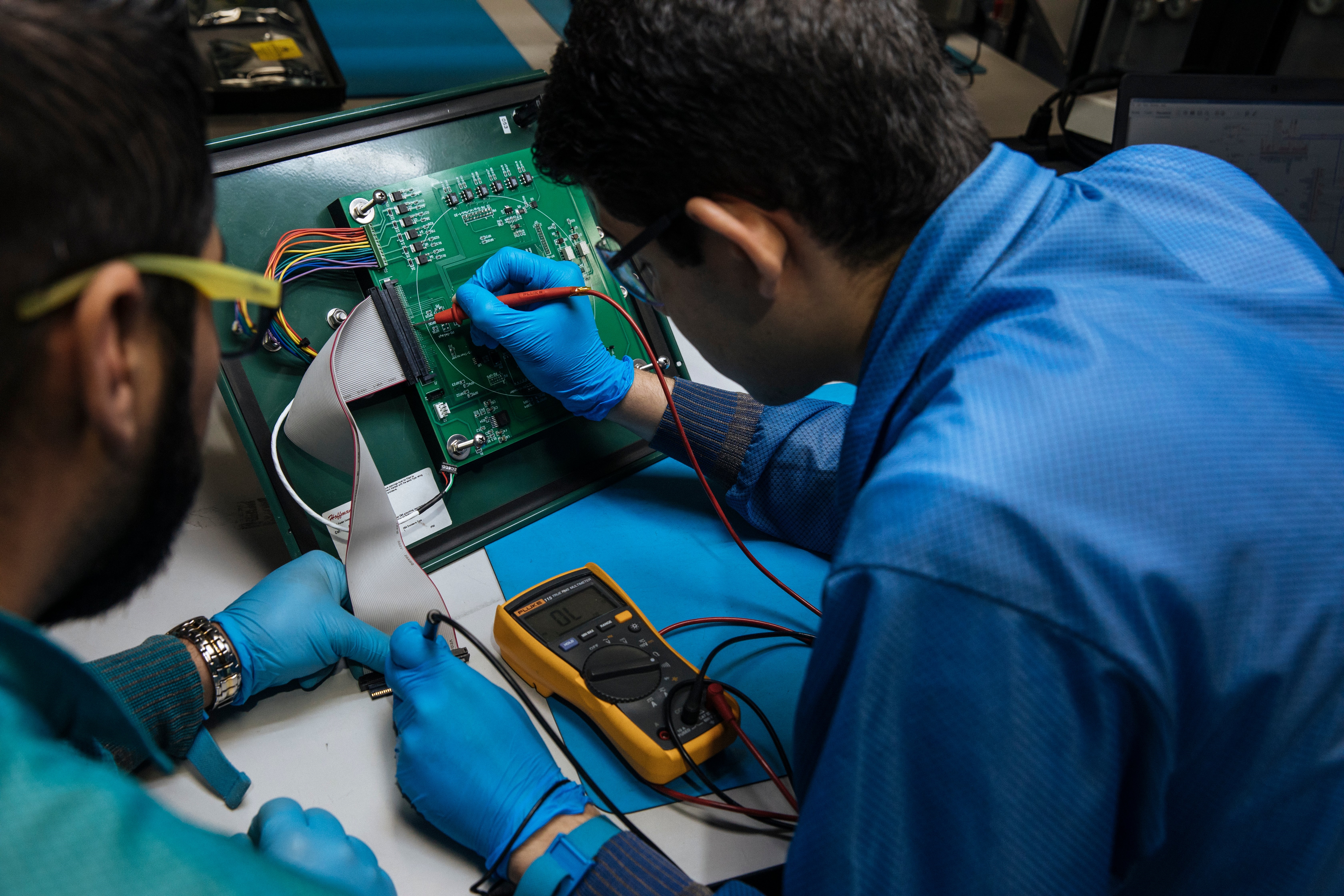 Engineer conducting functional testing on a prototype PCB