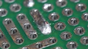 Microscopic inspection revealing via stub in 6-layer PCB for troubleshooting