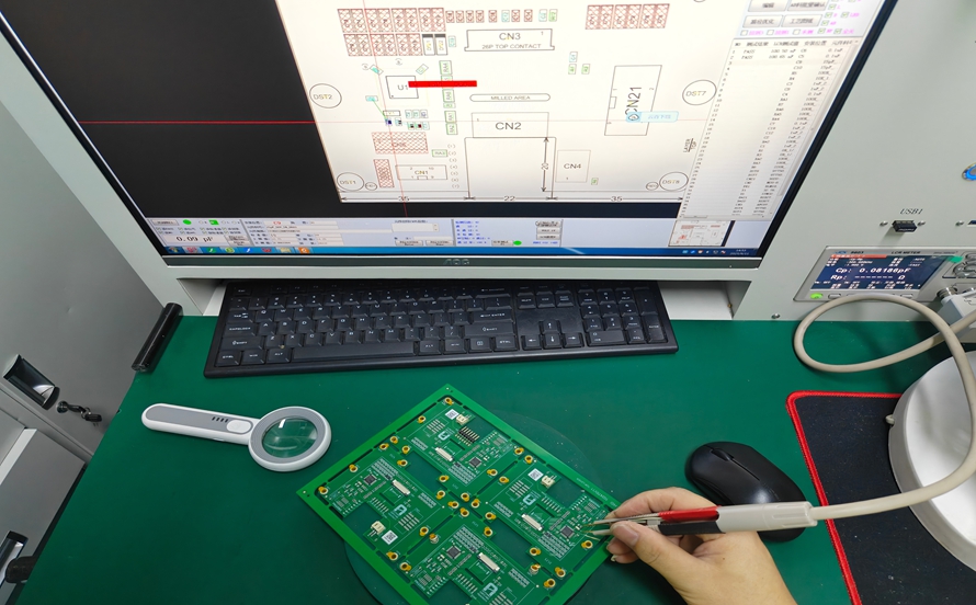 A computer display showing measured resistance and capacitance values of tested PCB components