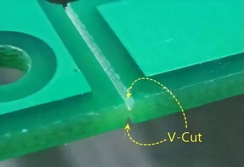 Close-up of V-shaped grooves on a PCB panel for depaneling