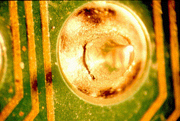 Close-up of cracked solder joints due to thermal stress